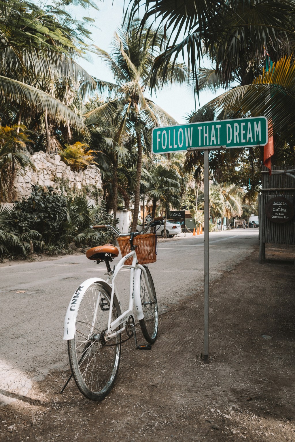 Bicycle in street next to Follow That Dream street sign
